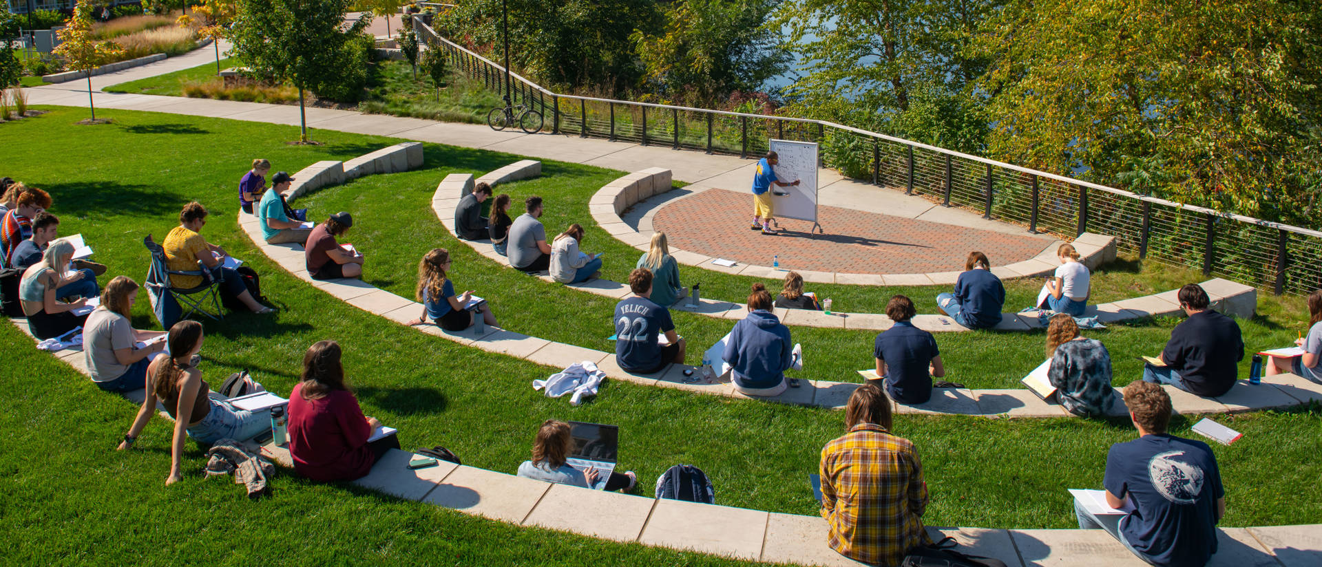 Students sit outside for class during a nice day on campus.
