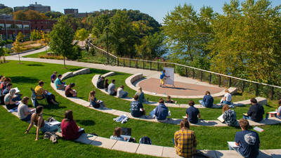 Students sit outside for class during a nice day on campus.