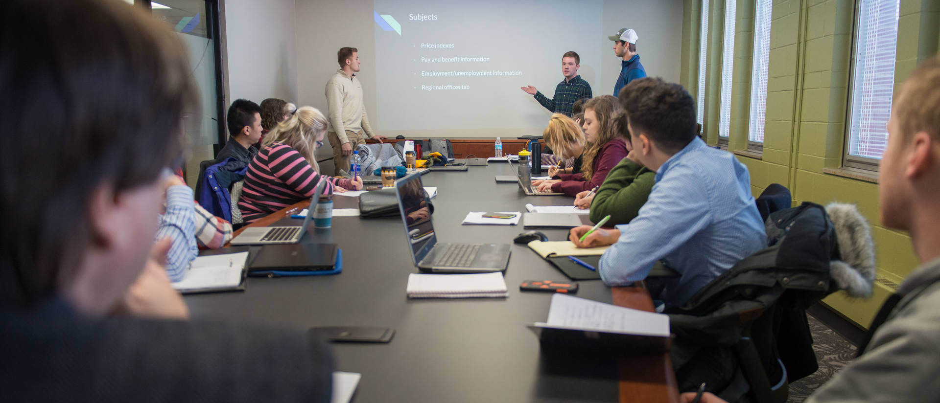 Students in an economics class watch a presentation.