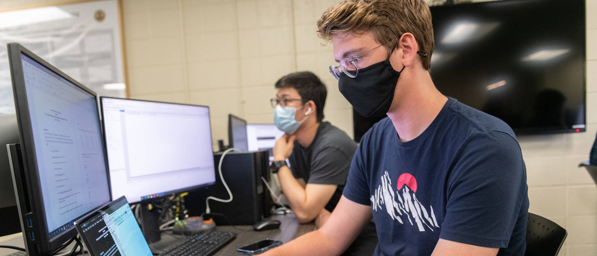 Students in a computer science classroom work on their computers.