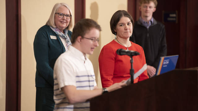 A student presents an award for disability advocacy to a professor