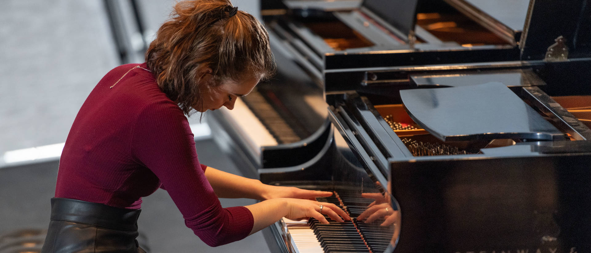 A person plays the piano during a performance.