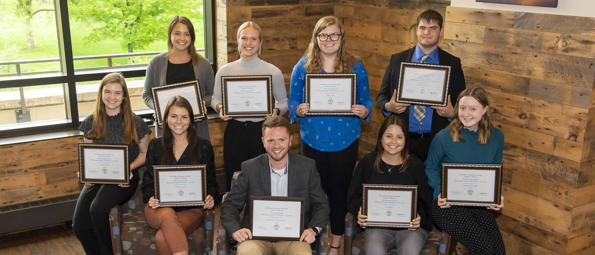 Management students holding certificates