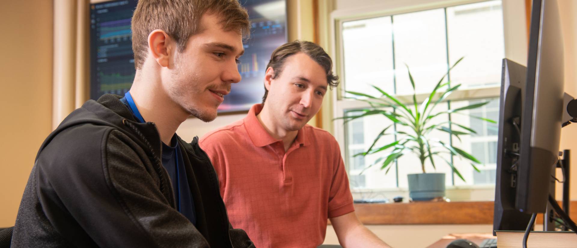 LTS staff and student collaborating at a computer station