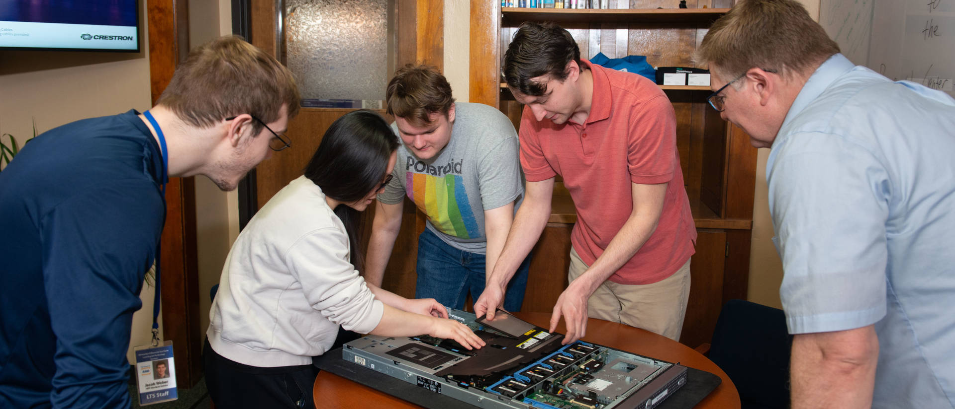 Students and staff from the Blugold Supercomputing Cluster investigating the internals of a server