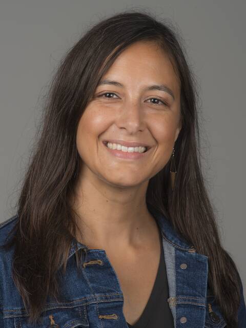 Woman with brown hair smiling.