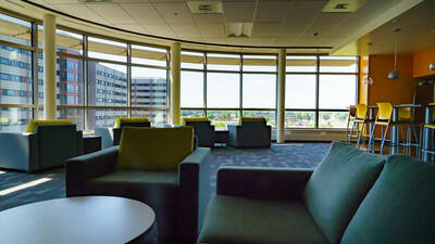 Kitchen with large windows overlooking campus and plenty of seating