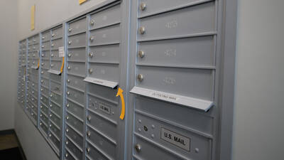 Silver mailboxes with unit numbers
