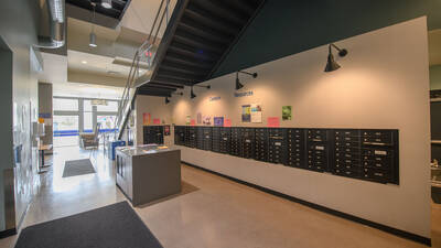 Key access mailboxes shown in a residence hall with the header "Campus Resources" on the wall