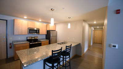 Kitchen with view of hallway where bedrooms and bathrooms can be accessed