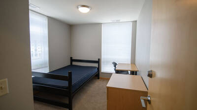 Single bedroom with twin XL bed, desk, chair and dresser