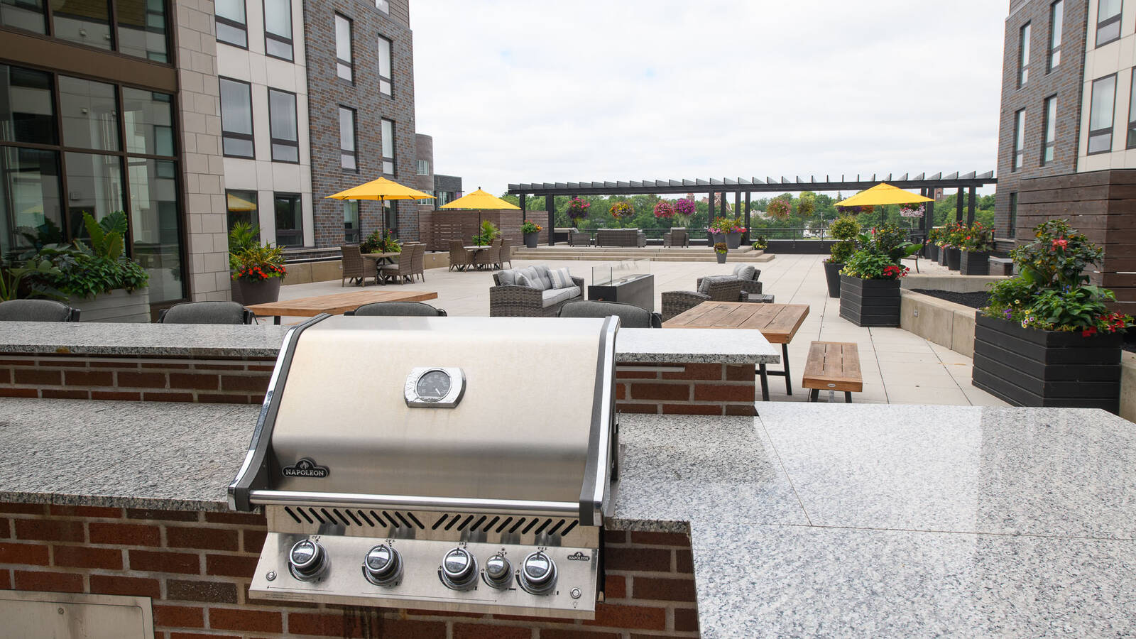 Haymarket Landing patio deck with view of grills for resident use and plenty of outdoor seating