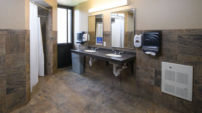 Residence hall bathroom showing showers and sinks