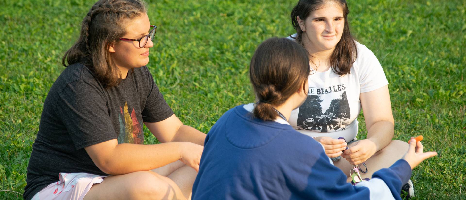 Honors students sitting in the grass