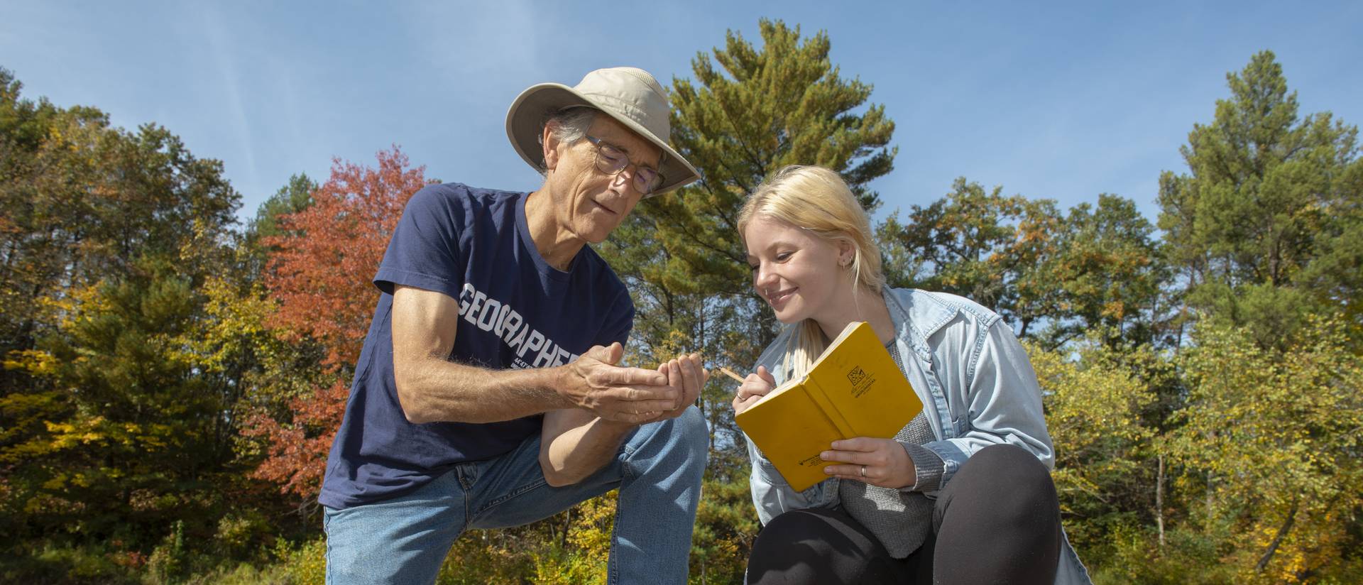 Dr. Douglas Faulkner, professor of geography, and Grace Bowe, an environmental studies major, examine the banks of western Wisconsin rivers as part of a faculty-undergraduate student research project. (Photo by Shane Opatz)