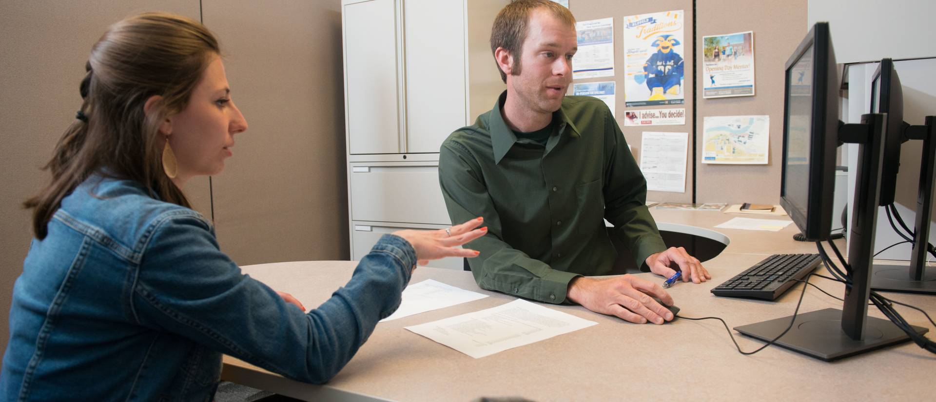 advisor helping student with academic planning in office