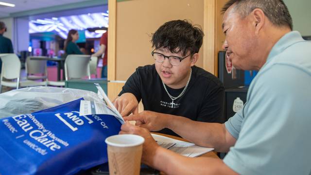 family member and student looking at papers together