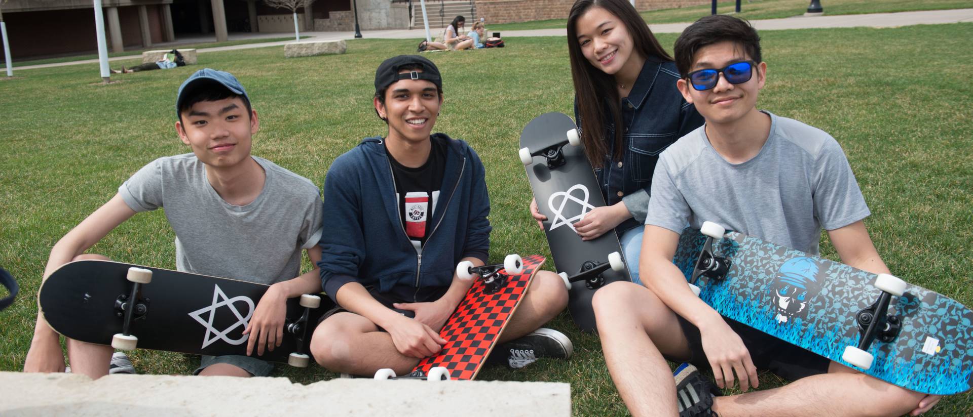 International students hanging out together with skateboards