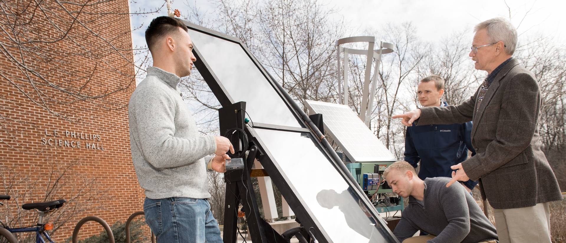 Blugolds work on a solar panel on campus