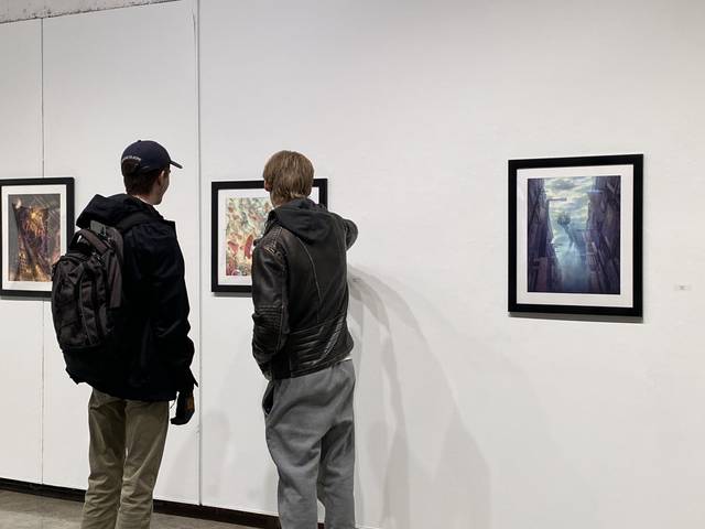 Photo of two gallery visitors viewing artwork in the Foster Gallery