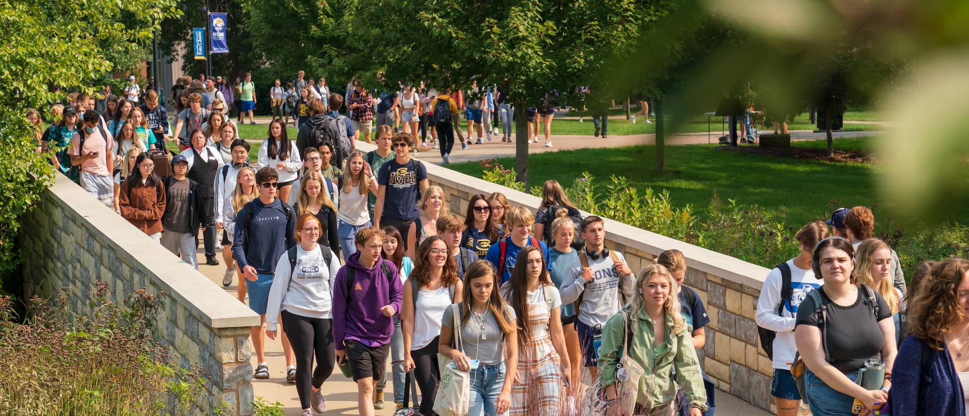 Students make their way through lower campus on a warm summer.