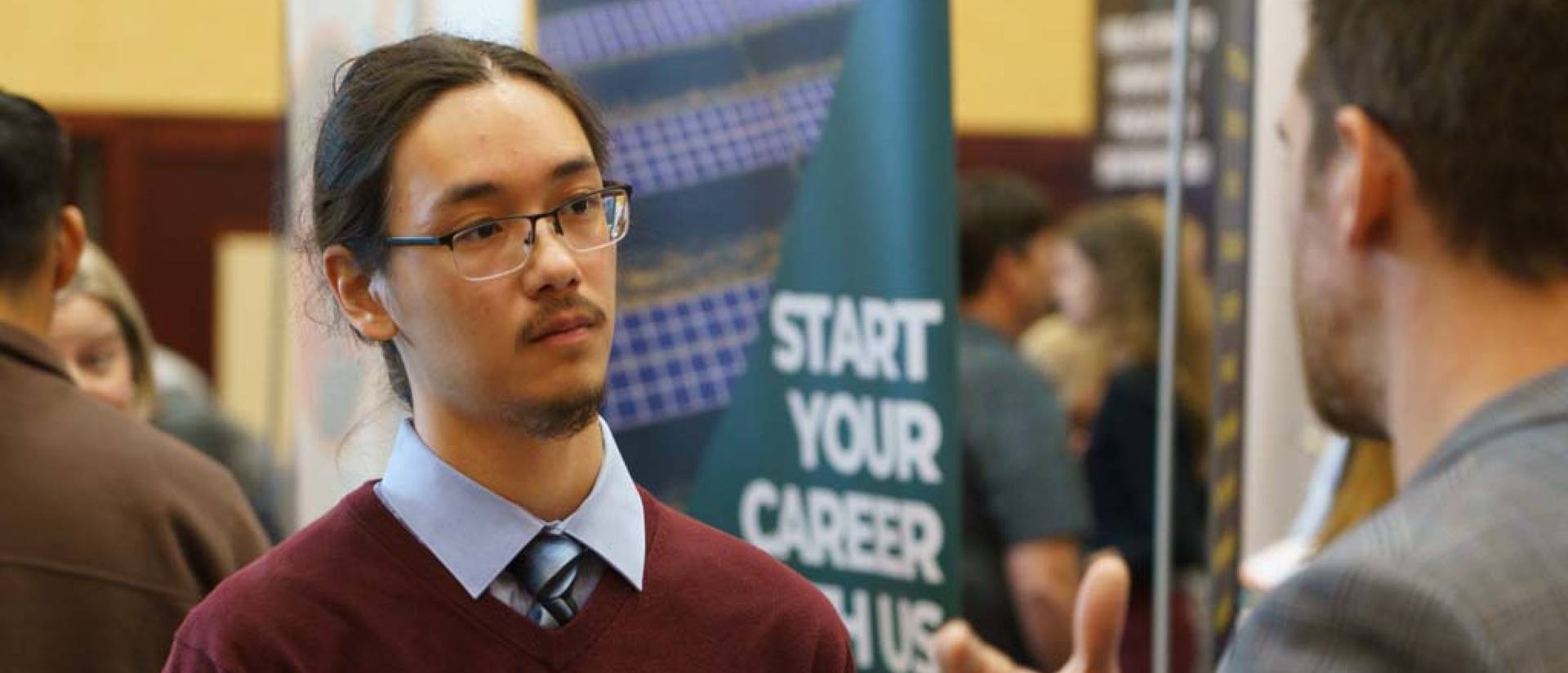 A student interacts with an employer at a Career Fair.