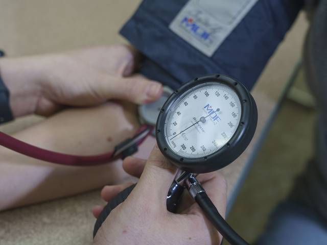 blood pressure cuff in use on a patient