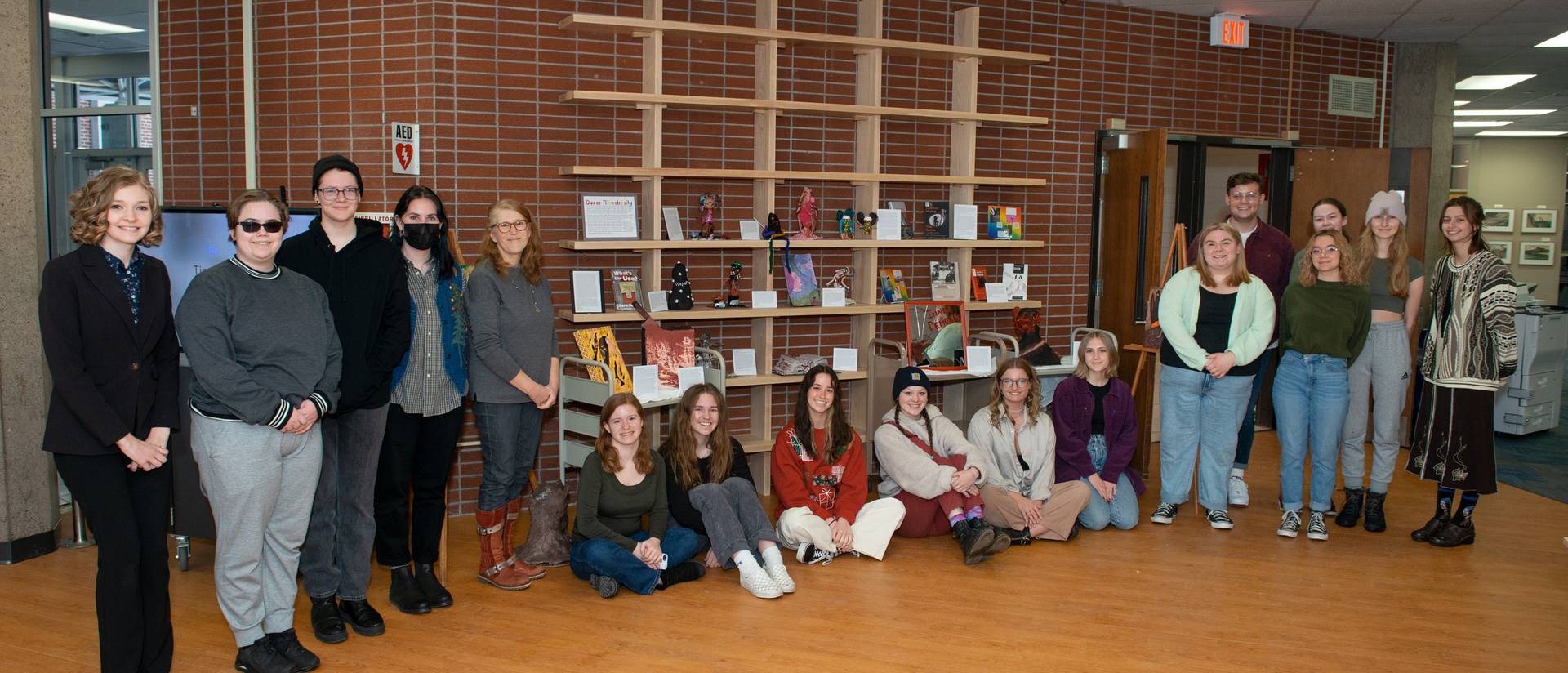 students stand in front of their art projects