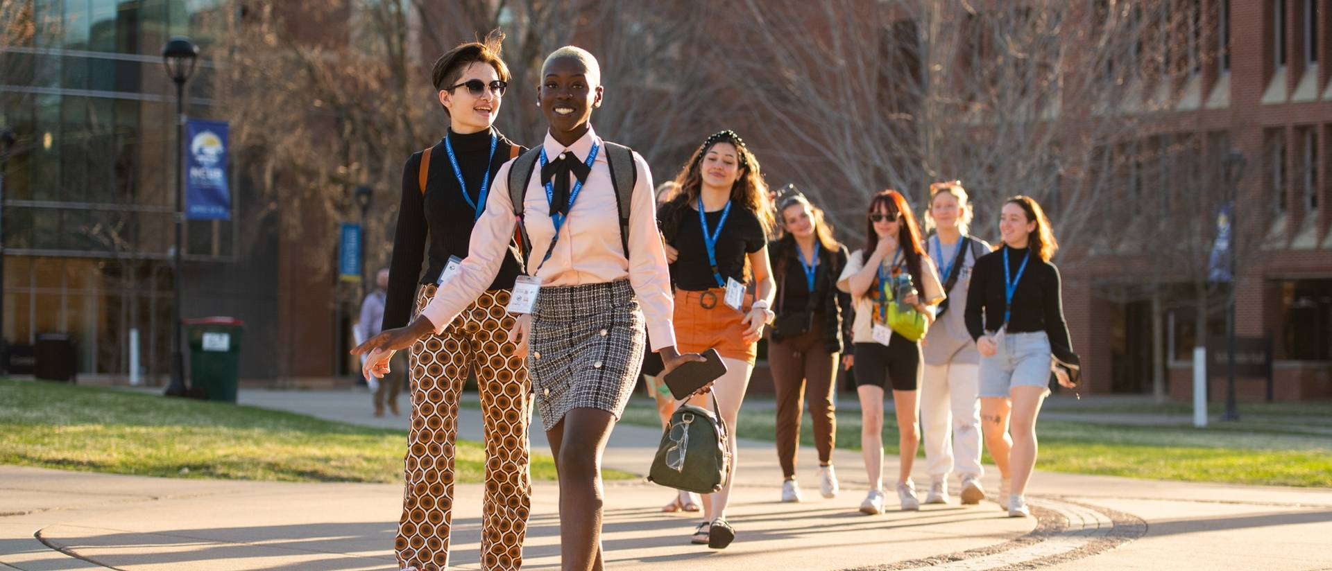 Group of students smiling while walking on UW-Eau Claire campus during NCUR 2023