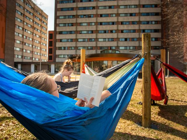 girls in hammocks on upper campus at UWEC, reading books