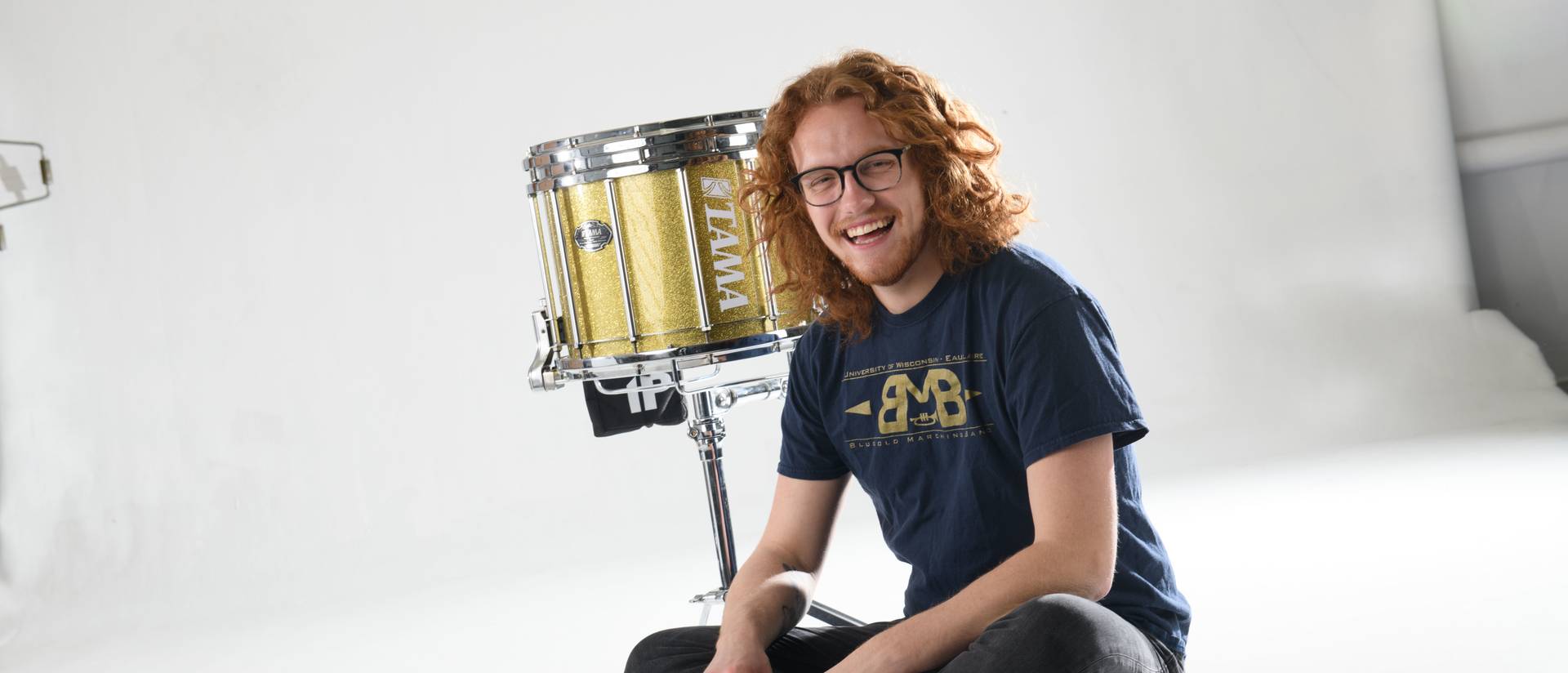 Andrew Smits in studio with drum drums and sticks stick