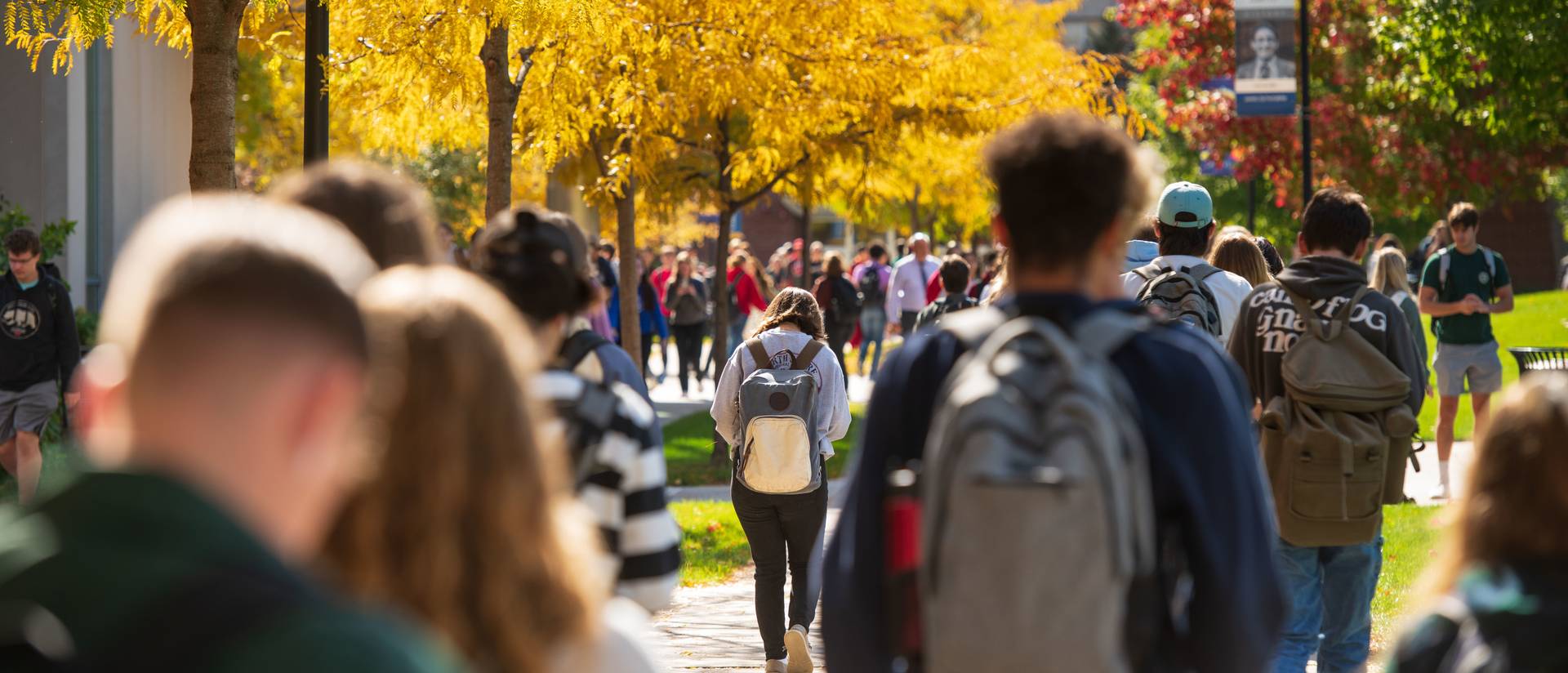 Students make their way through lower campus on a warm fall day.