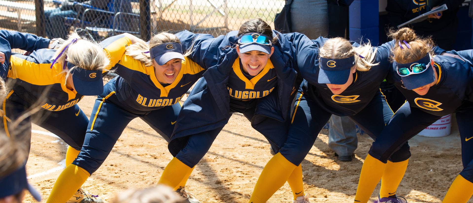 Members of the UWEC Women's Softball team huddle up during a game against UW-Stout.