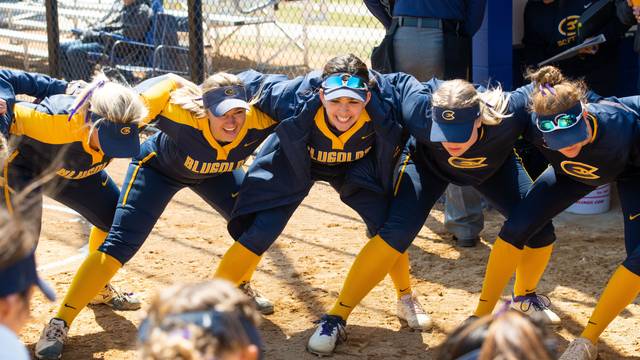 Members of the UWEC Women's Softball team huddle up during a game against UW-Stout.