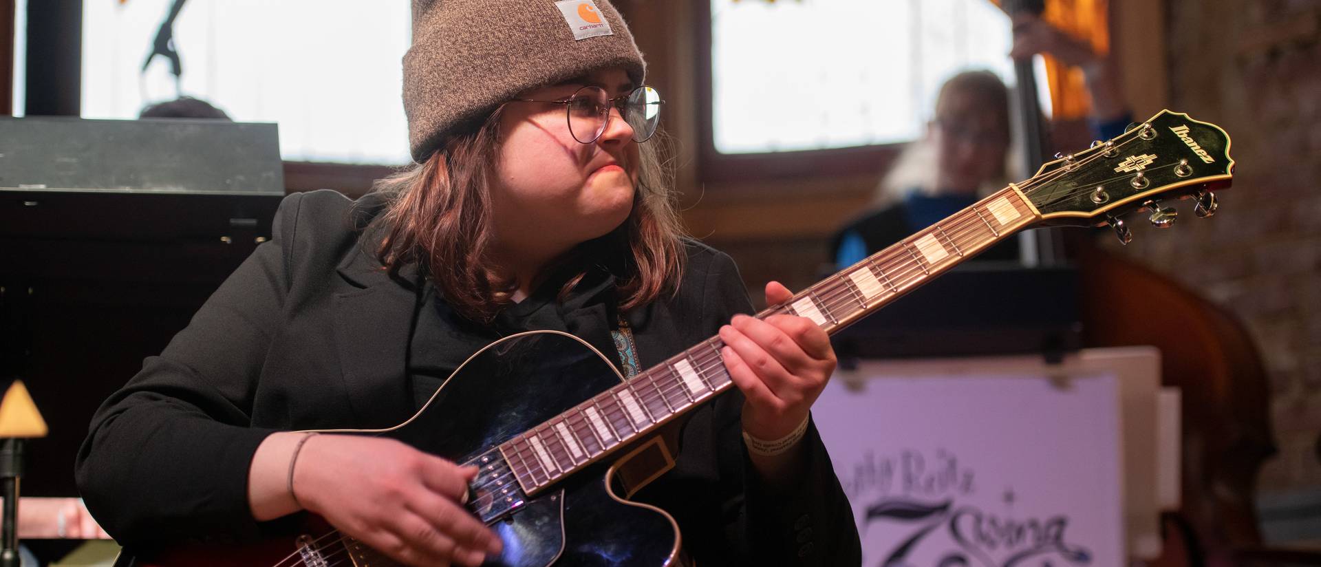 female guitar player at a jazz crawl venue