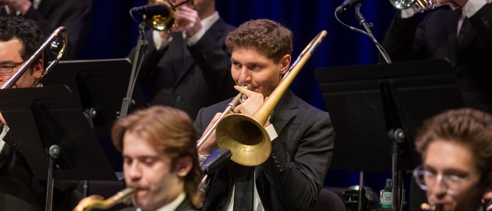 Male trombone player featured among band members