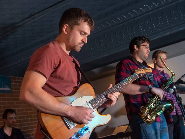 male guitar player on stage for Jazz Crawl