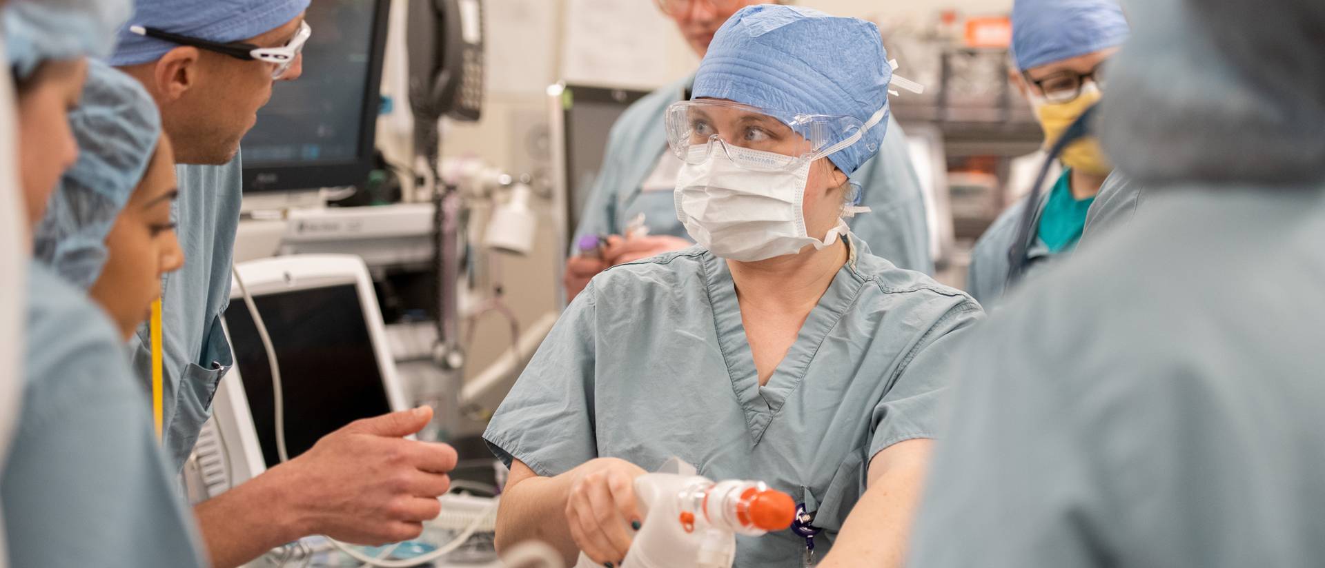 female student in the center of Mayo staff simulating a code blue