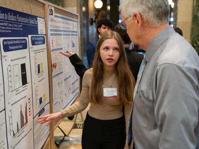 female student presenting research poster in the Madison capitol rotunda