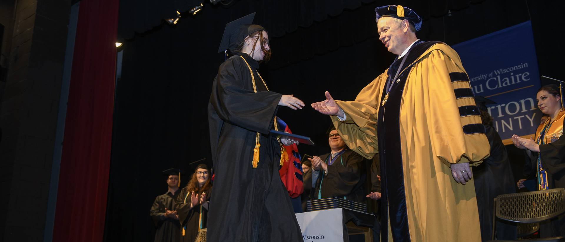 student shaking Chancellor Schmidt's hand at UW-Eau Claire Barron County