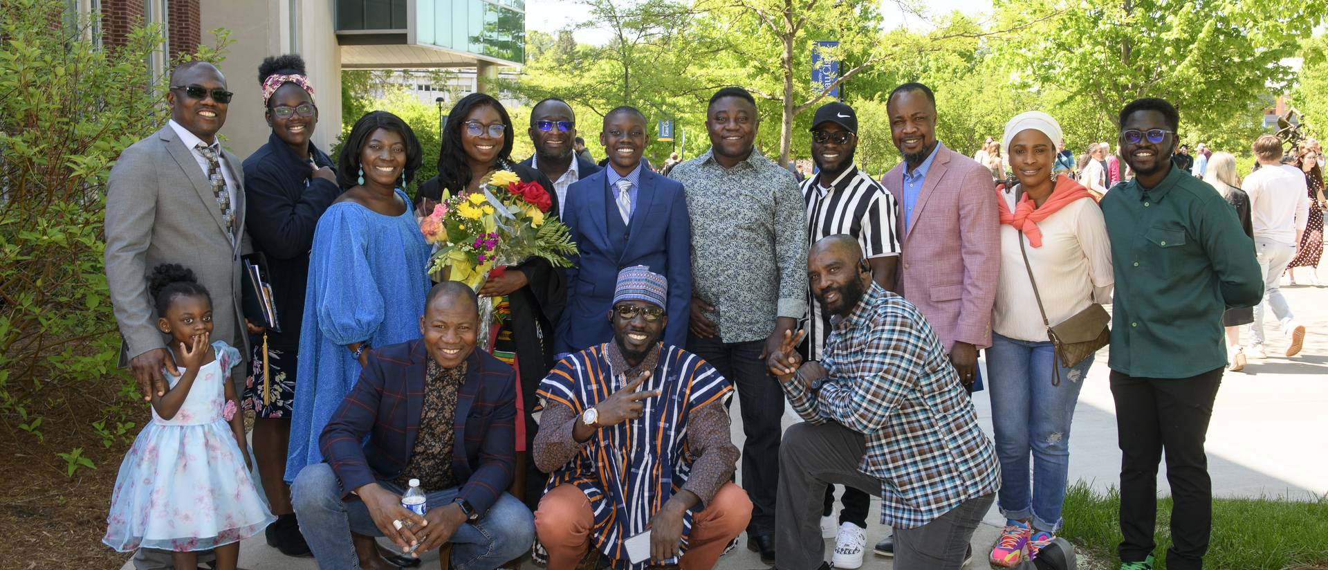 large family group shot from graduation, some members in traditional African clothing