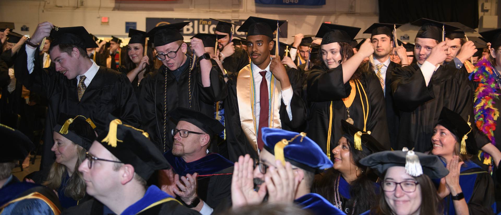 graduates tossing the tassel on their caps