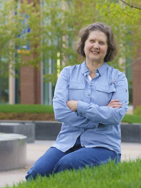 Daria Hutchinson sitting by the Sprites statue