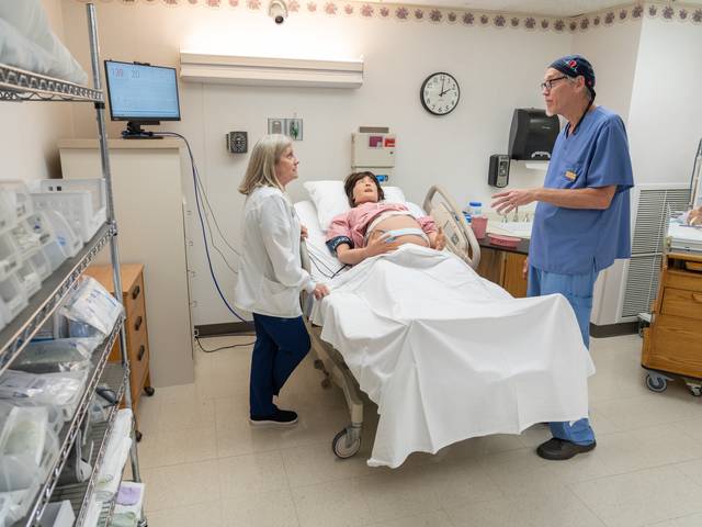 Nursing faculty working with new simulation manikin