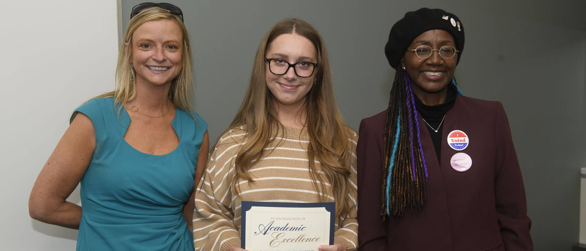 Professors Nicole Schultz and Rose-Marie Avin with student and award.