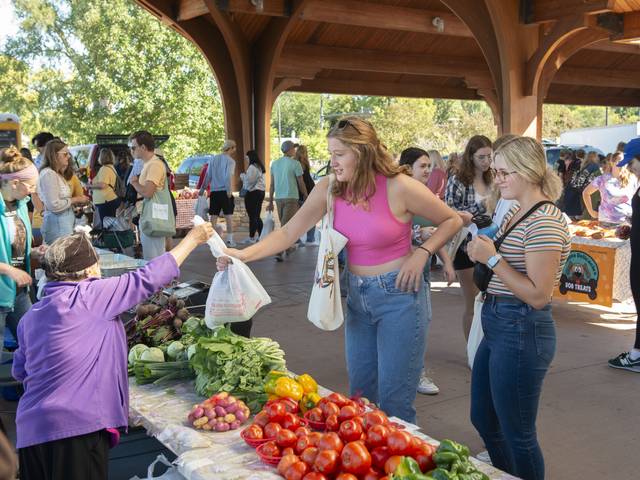 students at the Farmers' Market making a purchase