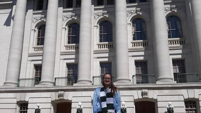 student in front of state capitol