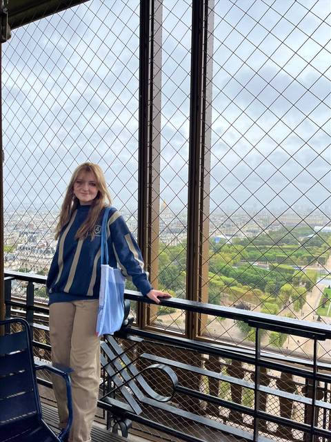 Sarah Warren poses on bridge in France