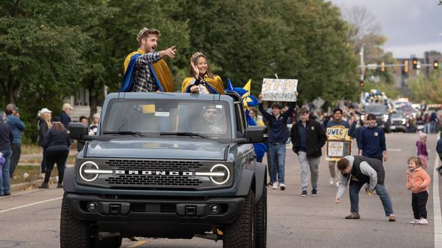 Homecoming royalty in a Bronco during 2023 Homecoming parade for UWEC