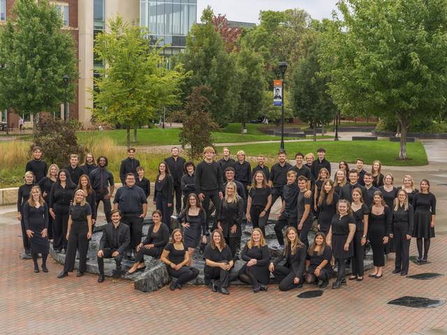 2023 Concert Choir members in front of a fountain on the UW-Eau Claire campus